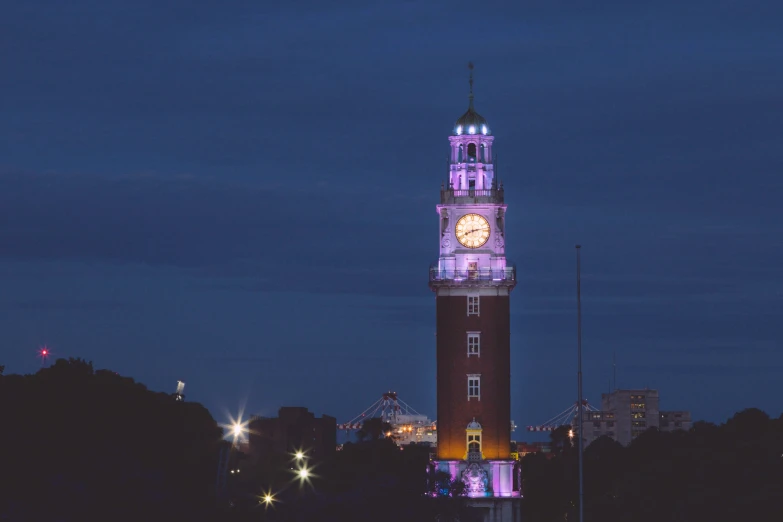 a view of a lit clock tower in the evening