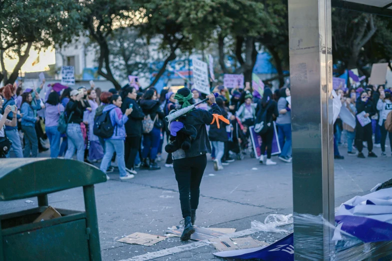 a group of protesters walking down a street