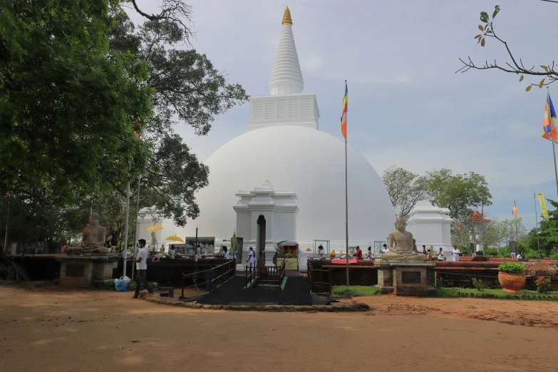 a large white structure in the background on a cloudy day