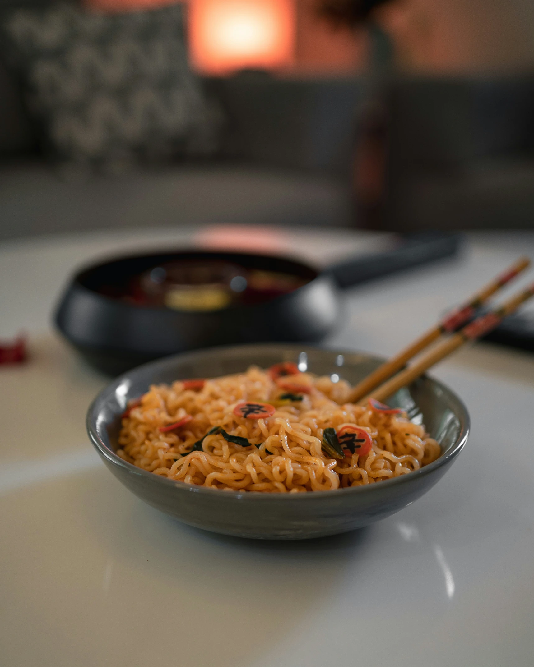 noodles in grey bowl on white table