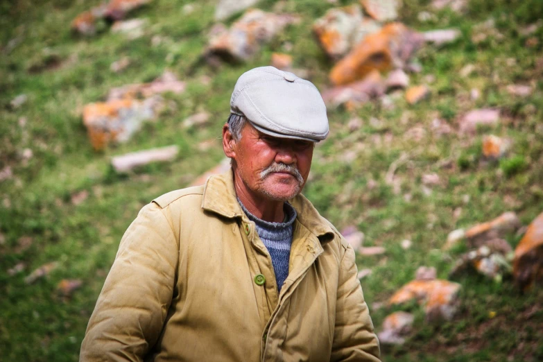 a man standing in the middle of some grass