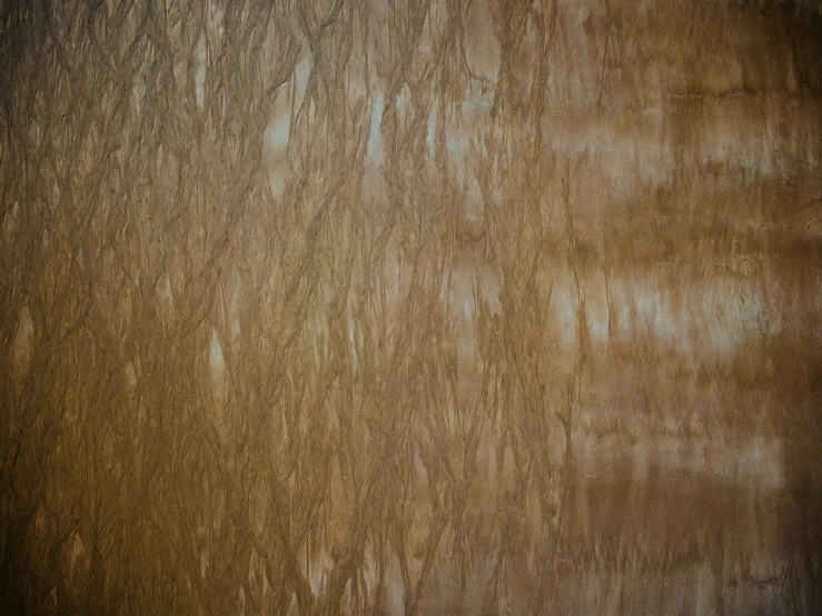 a textured wall in gold brown and silver