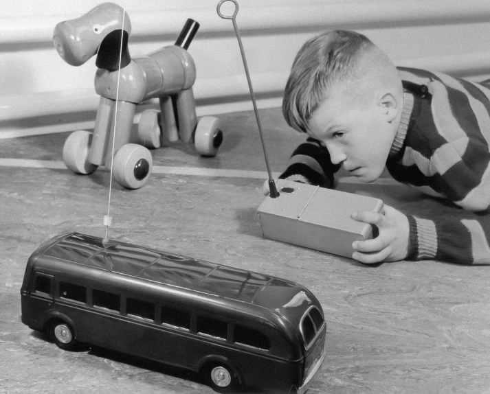 a young child laying on the ground playing with toys