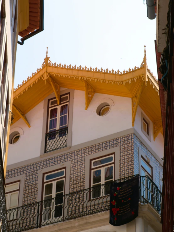 an old white building with balconies and wrought iron balcony