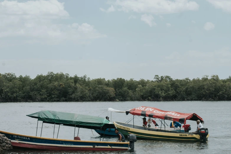 two boats in the water near a river