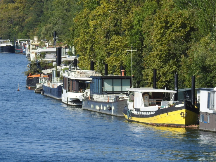 several boats are docked in the water and people are walking on the deck