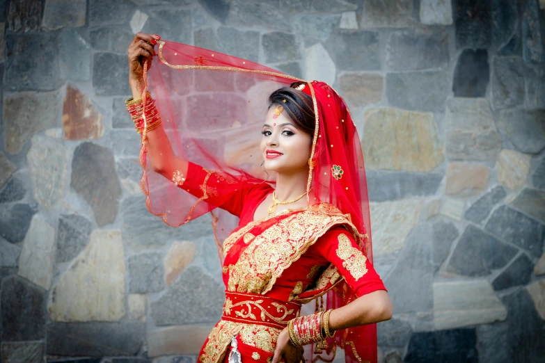 a beautiful young woman in a red and gold outfit