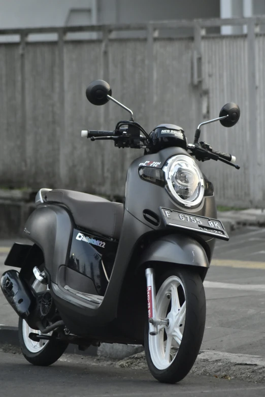 a scooter sits parked in a parking lot