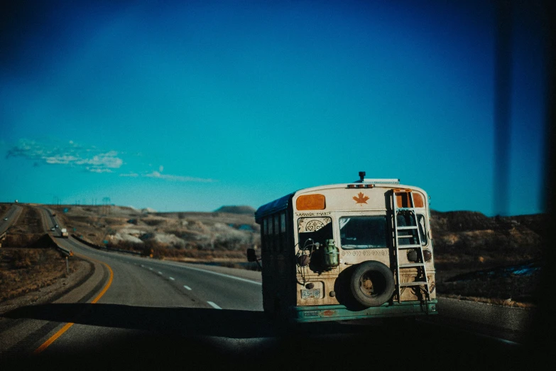 a bus traveling on the highway on a partly cloudy day