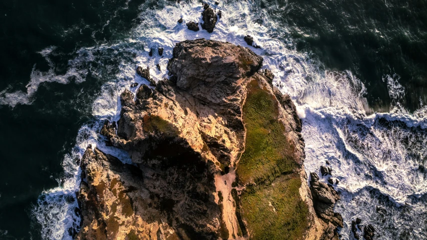 a rock outcropping near the ocean with water