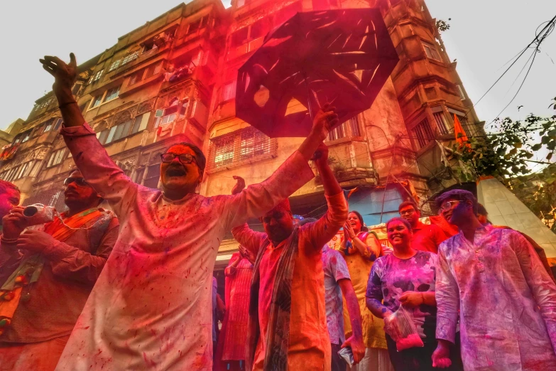 people gathered outside with colored paint on their faces