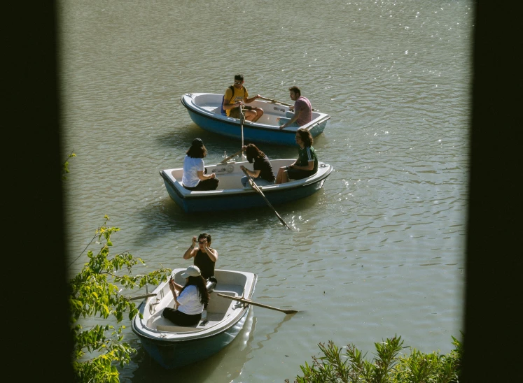 people in small boats floating on the water