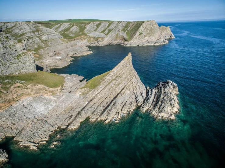 a rock formation is seen on the coast