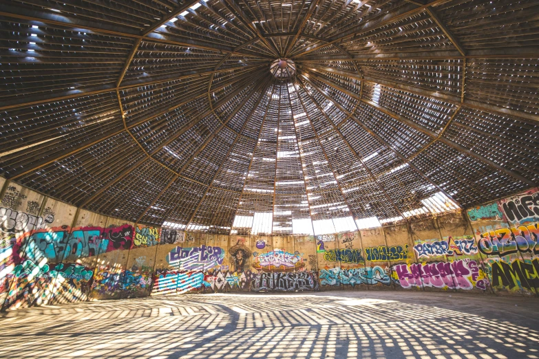 a building with lots of graffiti and some wood structure