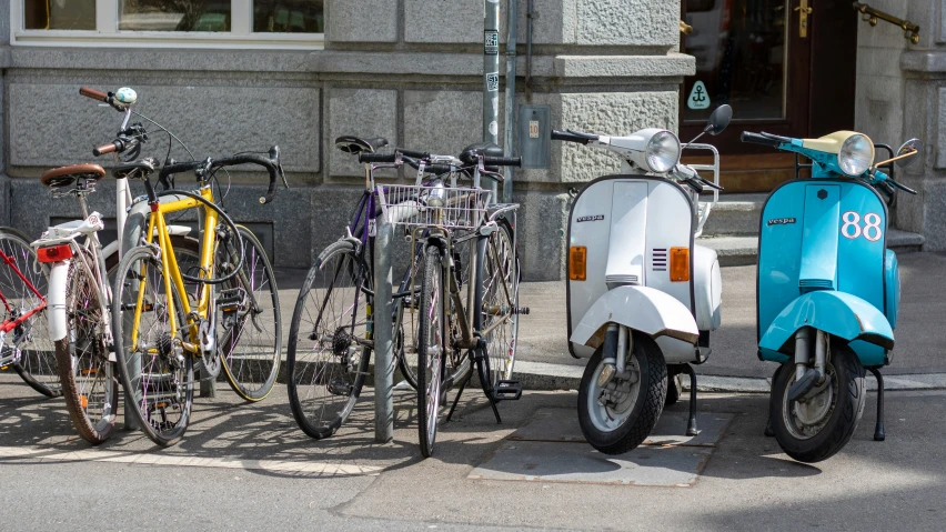 several bikes are parked beside each other in front of a building