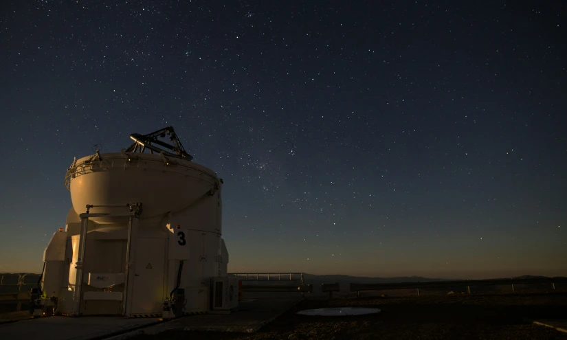 an old telescope tower in the middle of the night