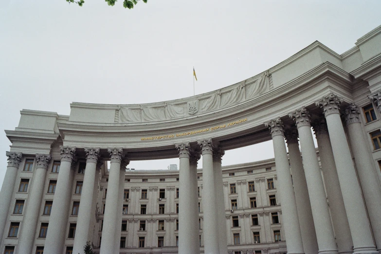 a building with columns on either side and the sky in the background