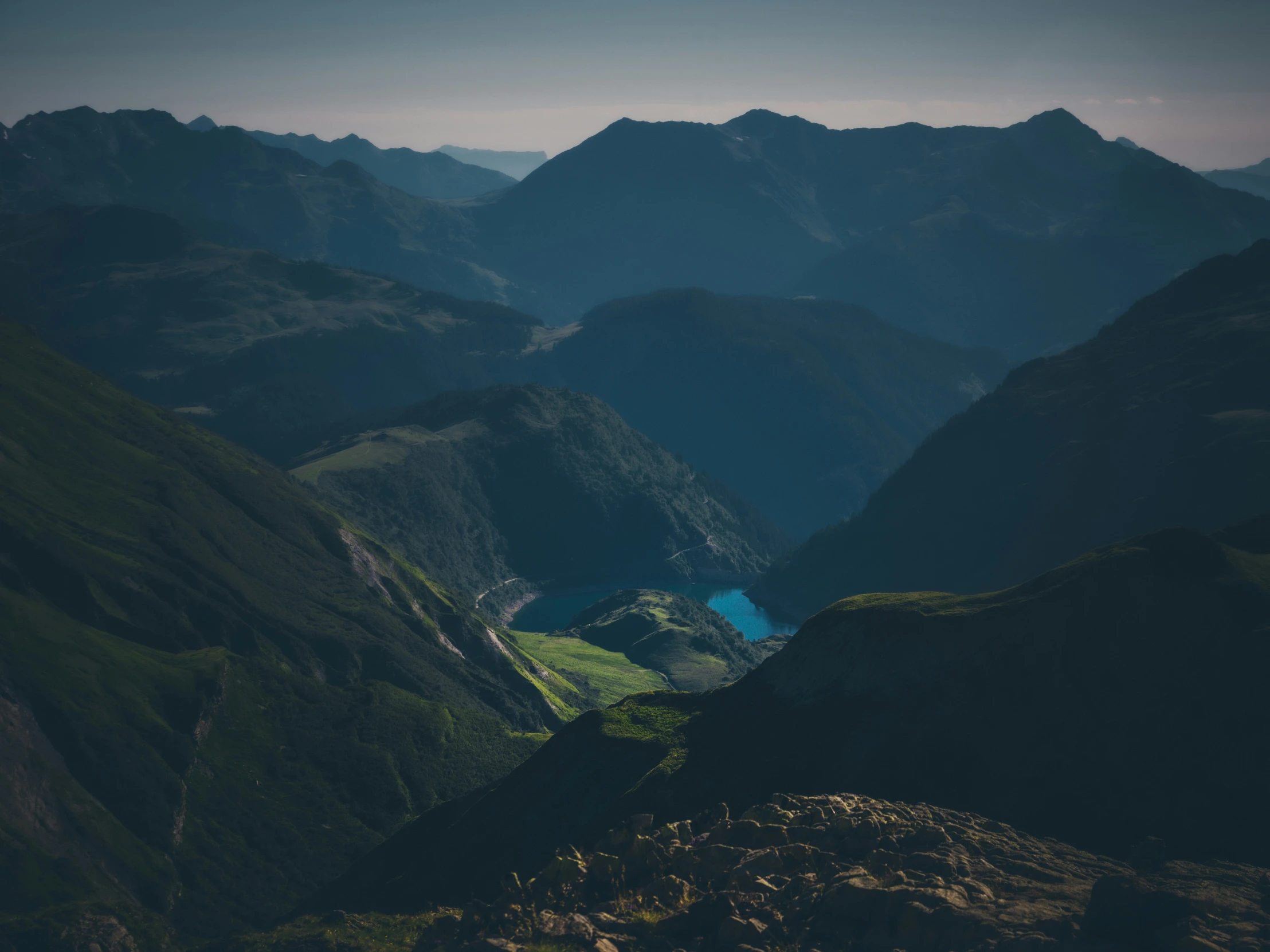 the view of a valley in the middle of mountains