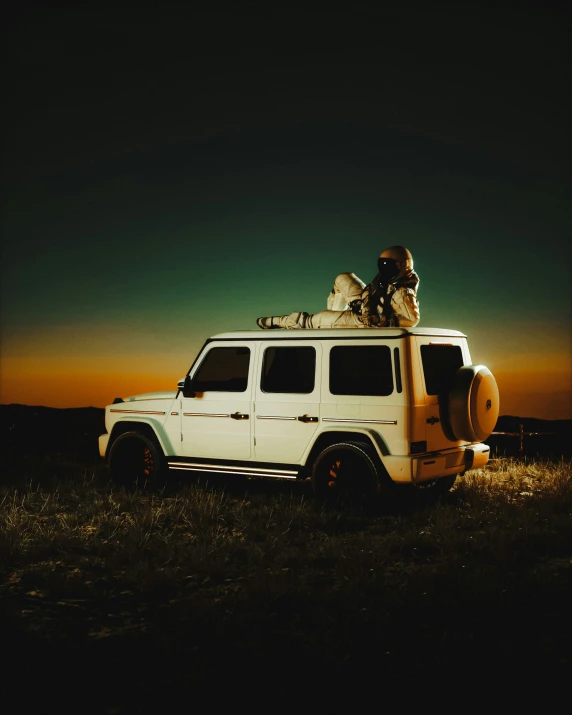 a jeep is parked with its light on and luggage on top