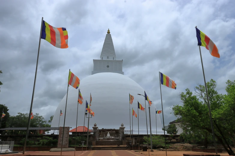 an image of a large white dome and lots of flags