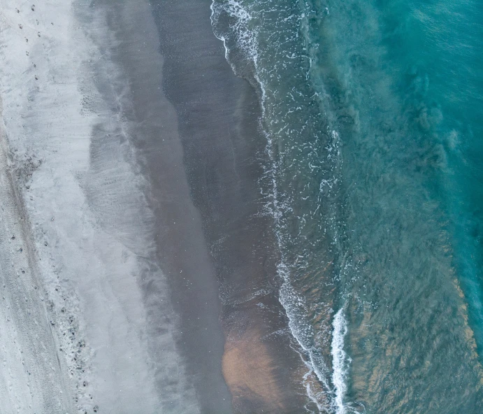 an aerial view of the water near a beach