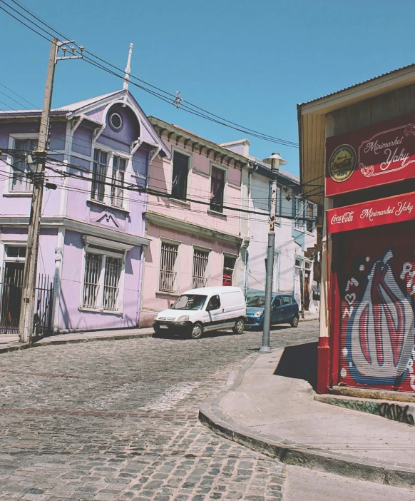 a very long colorful street has a bunch of buildings