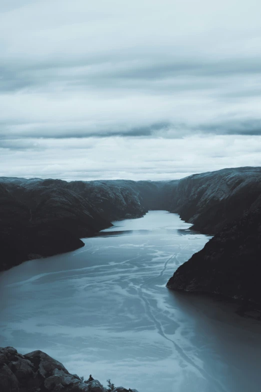 a river on a hill with many mountains near by