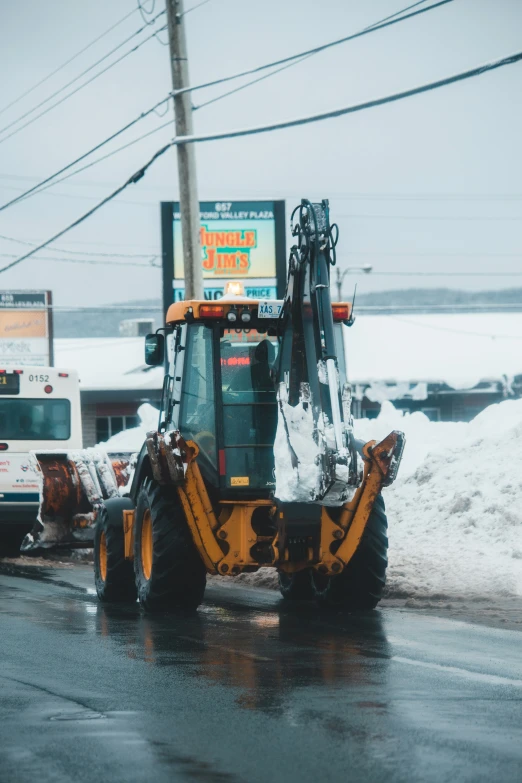 a tractor is driving down a street with a sign that says go out