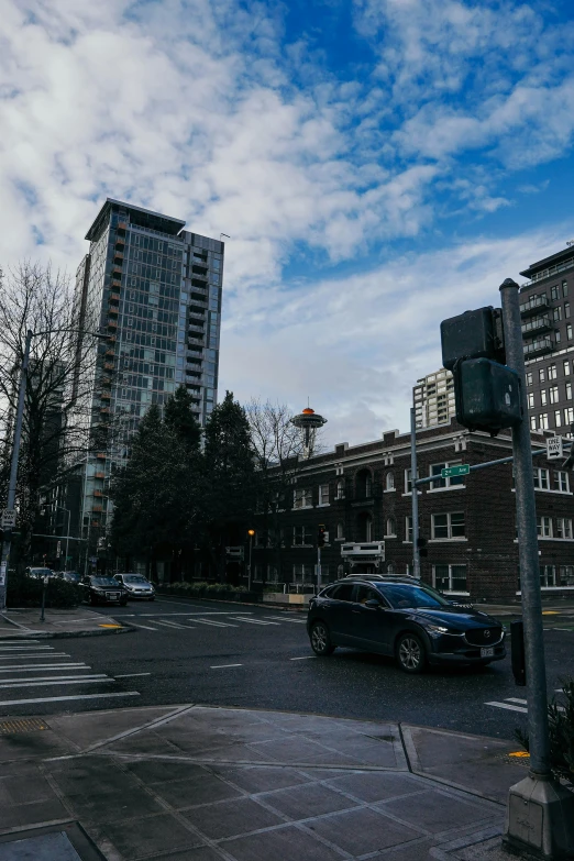 cars on a city street with buildings in the background