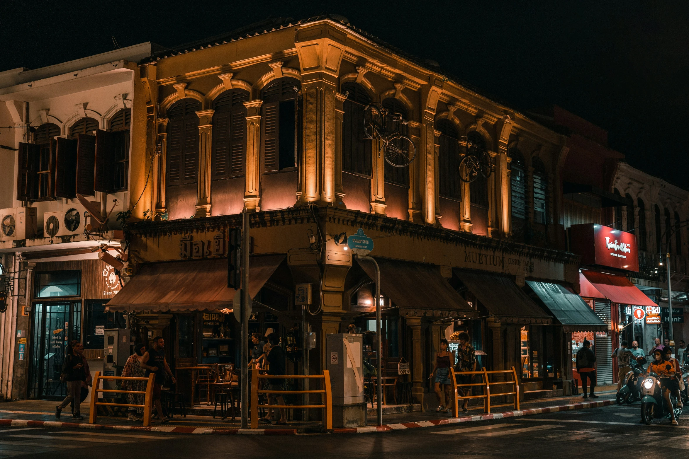 a building that has some lights on and a motorcycle parked in front