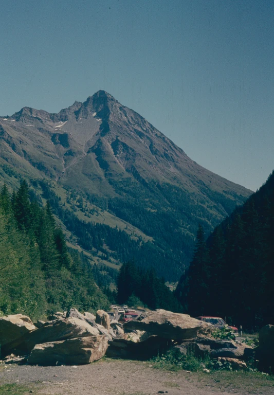 a man is taking a picture of a mountain range