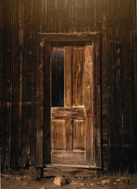 a wooden door is open on an old building