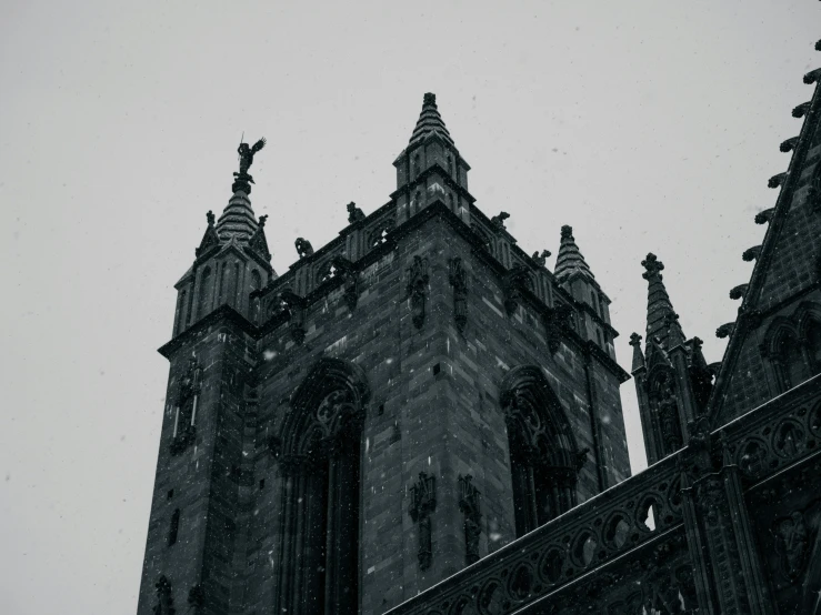 a gothic tower with large sculptures on top