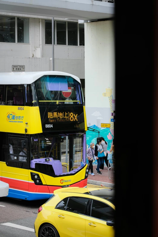 two story bus riding down the road in traffic