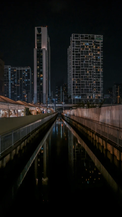 night time scene of canal leading to many skyscrs