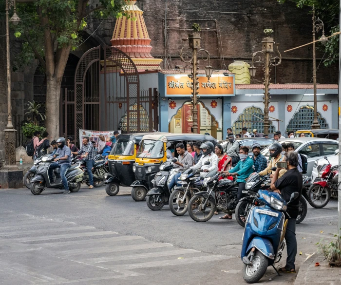 a group of people riding motorcycles and a scooter