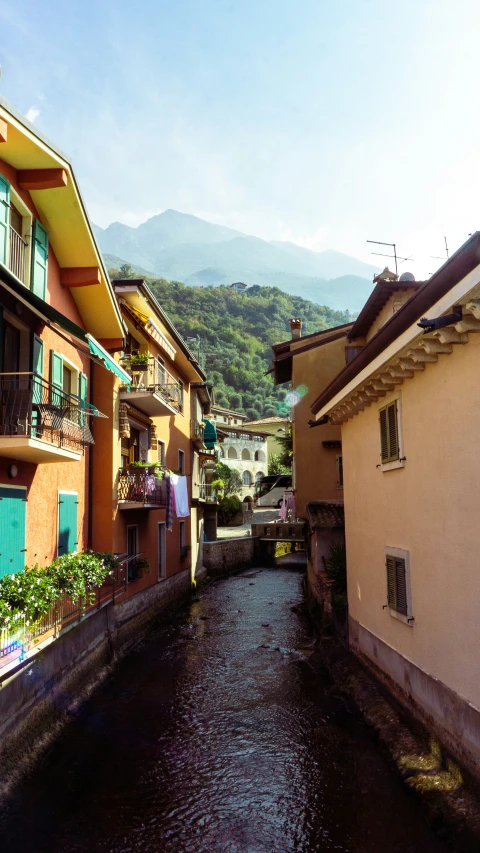 an alley in town that has a small river running through it