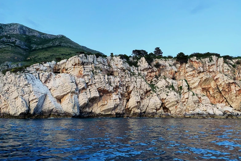 the mountains are very rocky by the water