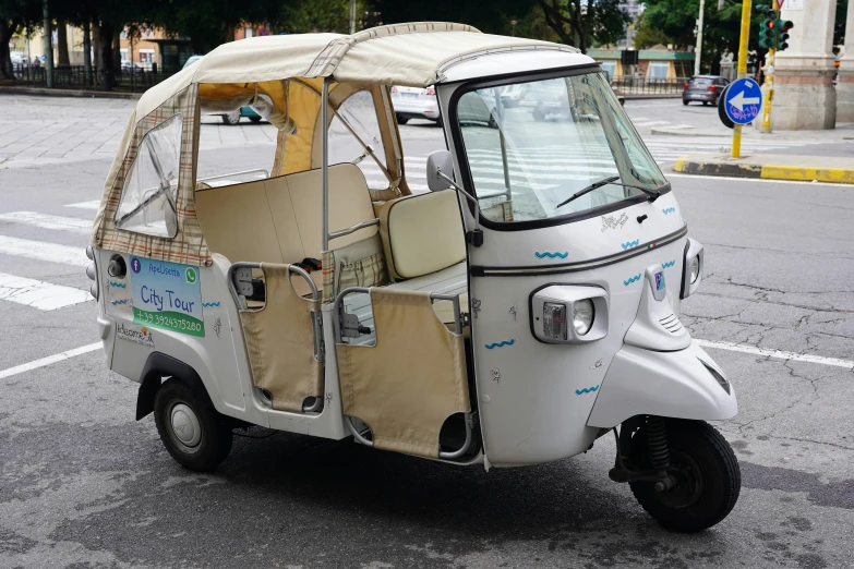 a small white motorized car in the city