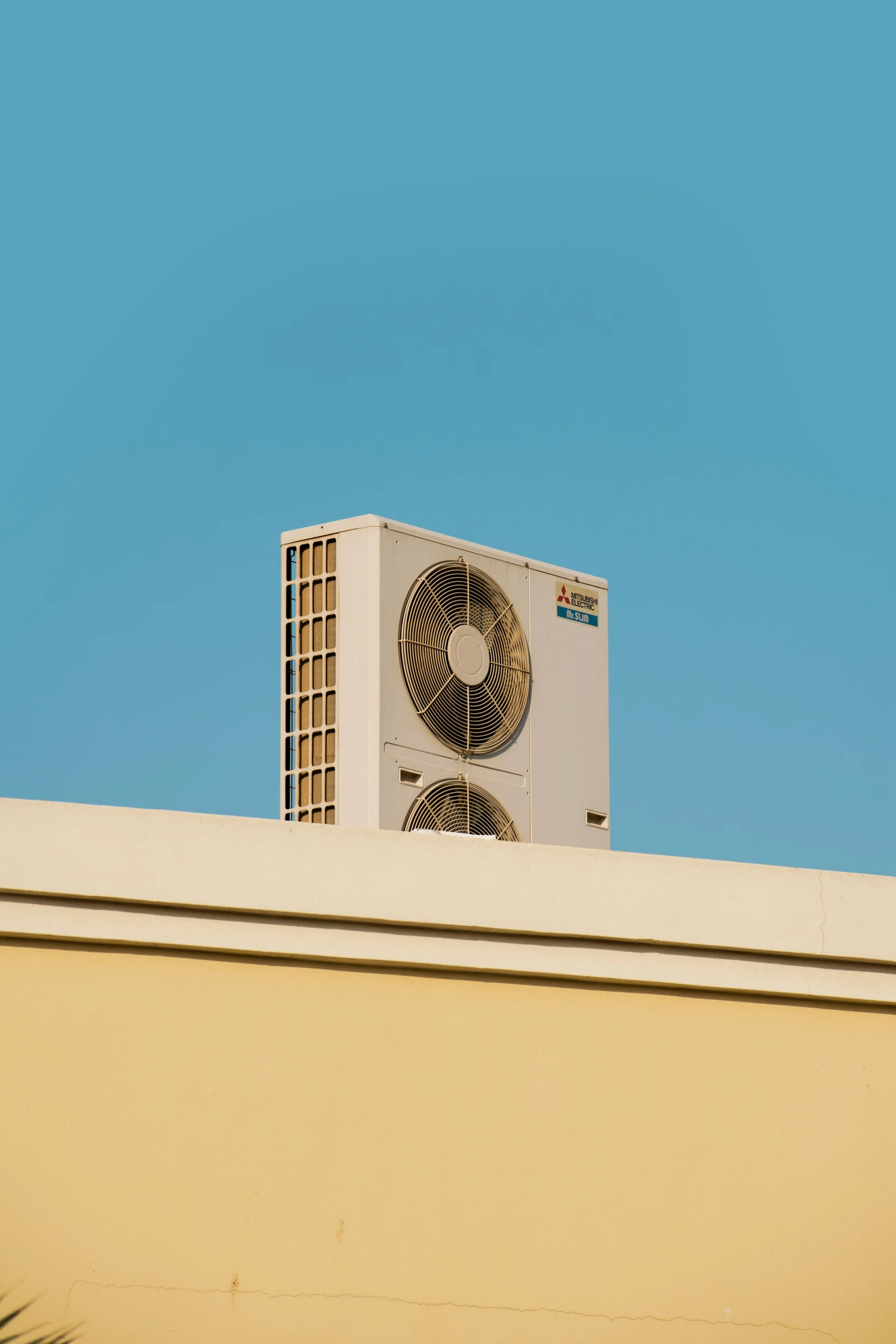 a white duct air conditioner sitting on top of a roof