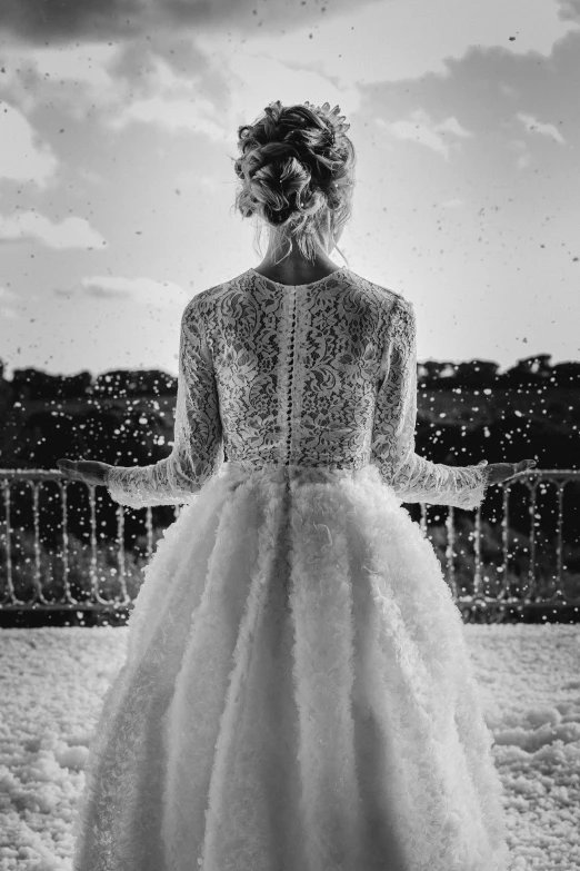 a woman standing on top of a snow covered field