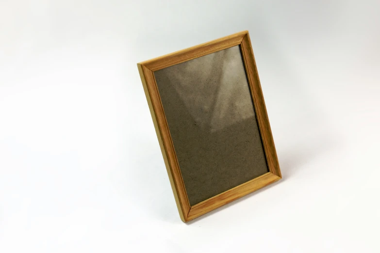 a wooden frame sitting against a white wall