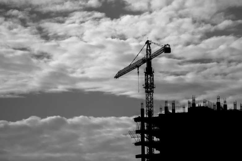 a crane is visible against the cloudy sky