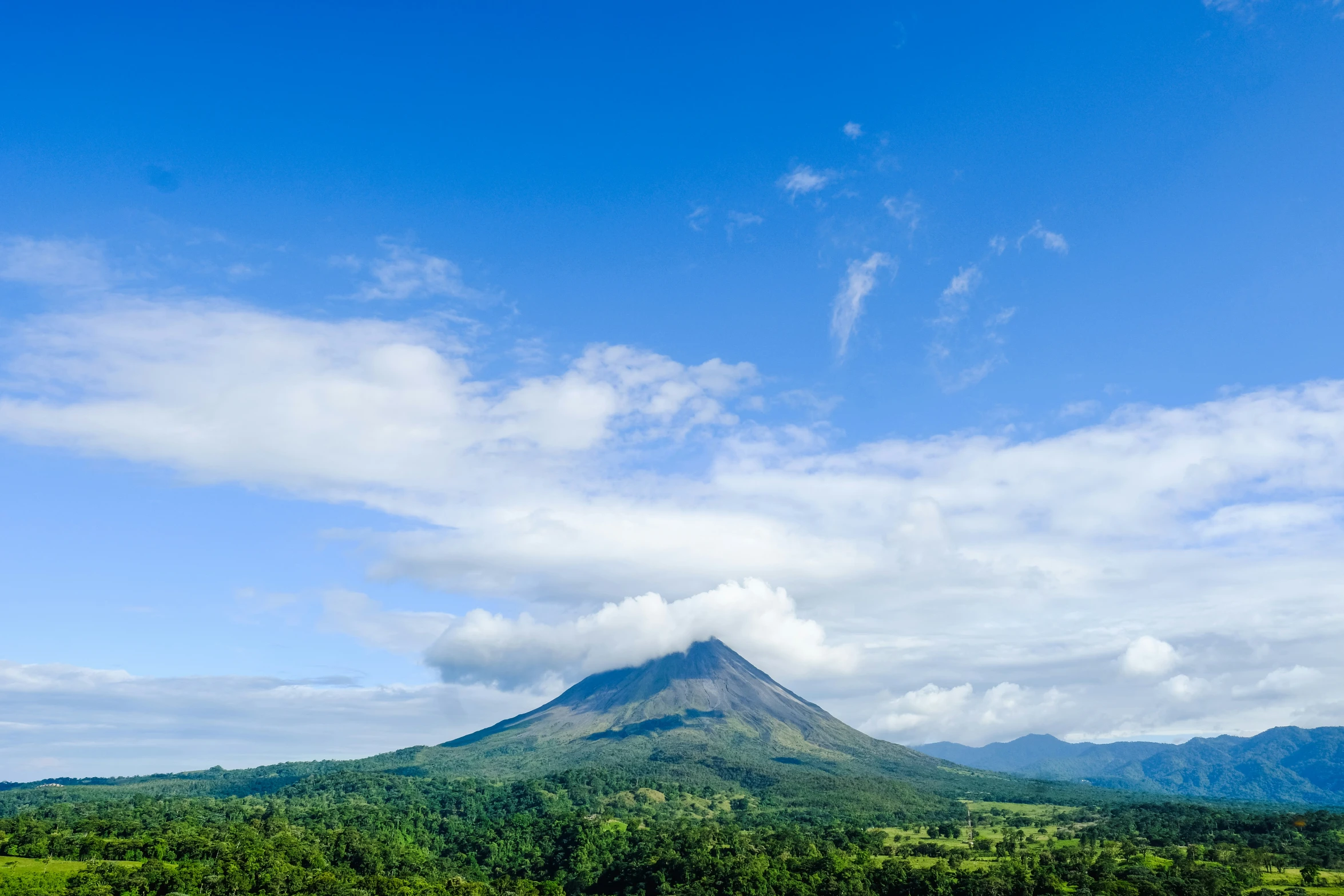 a distant view of the volcano, and its lush vegetation