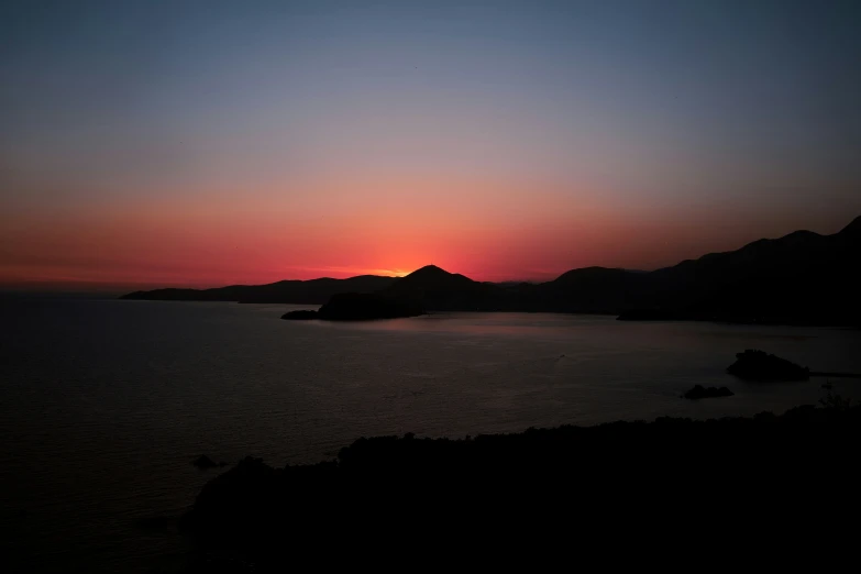 a sunset seen over a large body of water