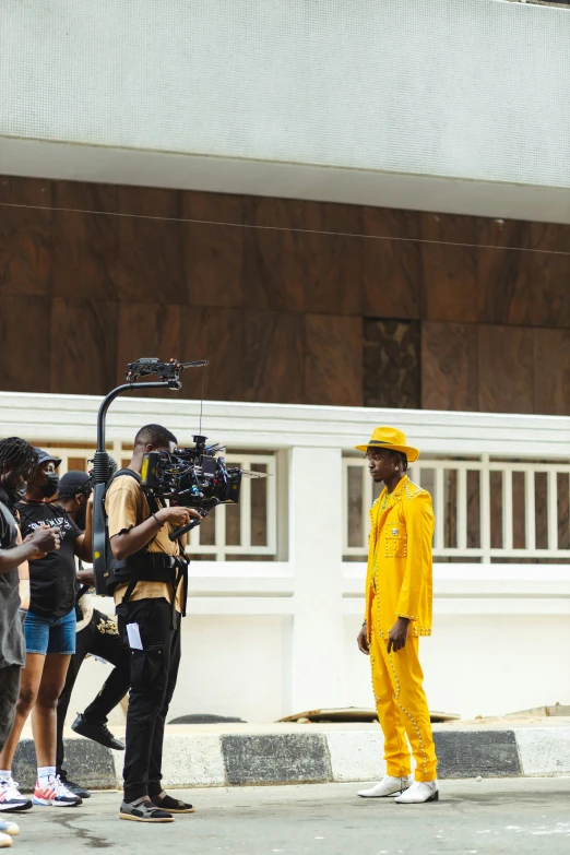 a man standing behind a camera while filming other people