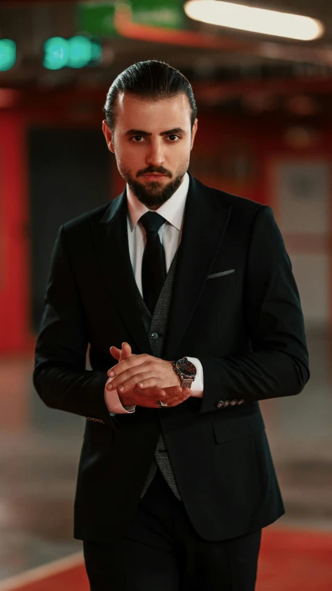 man in black suit with beard and cigar looking into camera