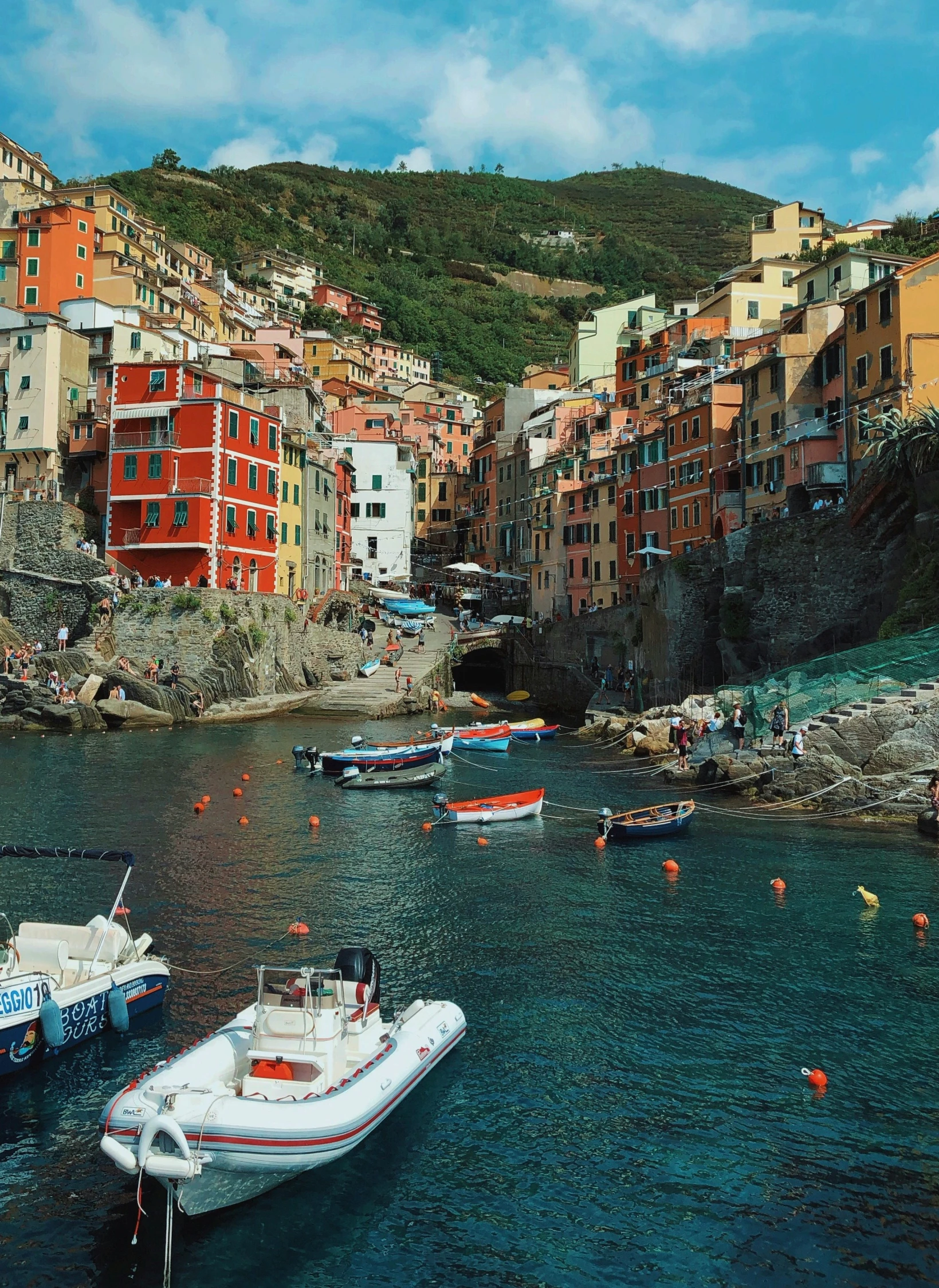 colorful boats in the water on a very picturesque bay