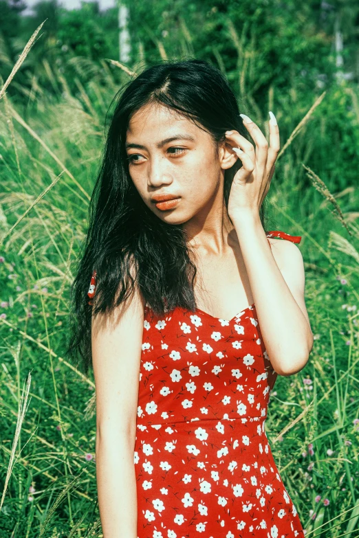 an asian woman in a red and white dress on her cell phone