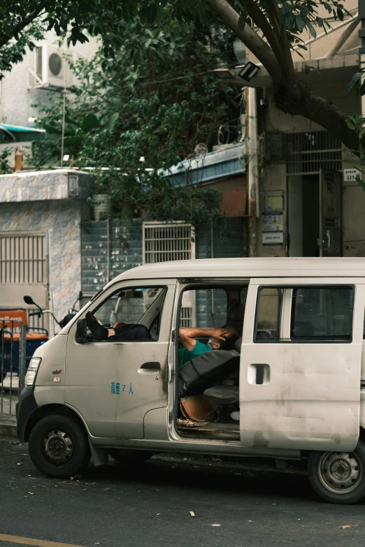 a man is sitting inside of a small van